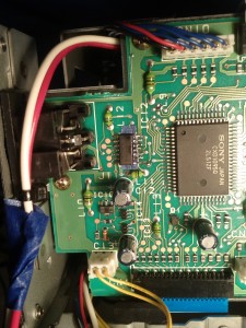 The repaired hex buffer. The blue area is some insulating tape. The left side is soldered to original pads; the right side is jumped to the board with thin wires.